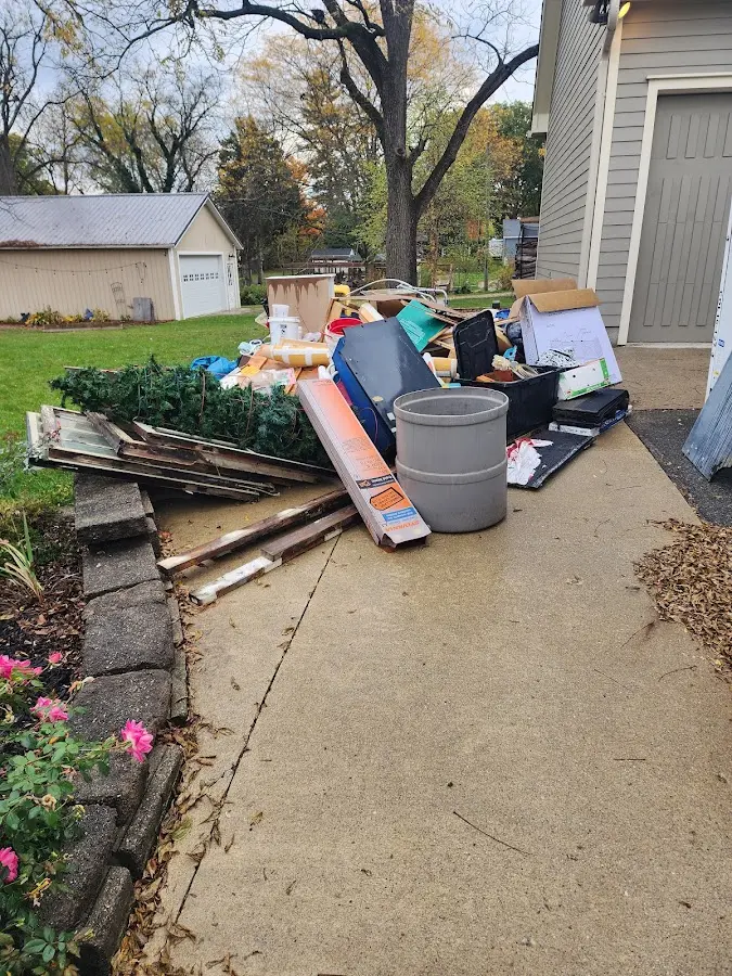 Dumpster being loaded with debris for Estate Cleanout Dumpster Rental in Fort Madison